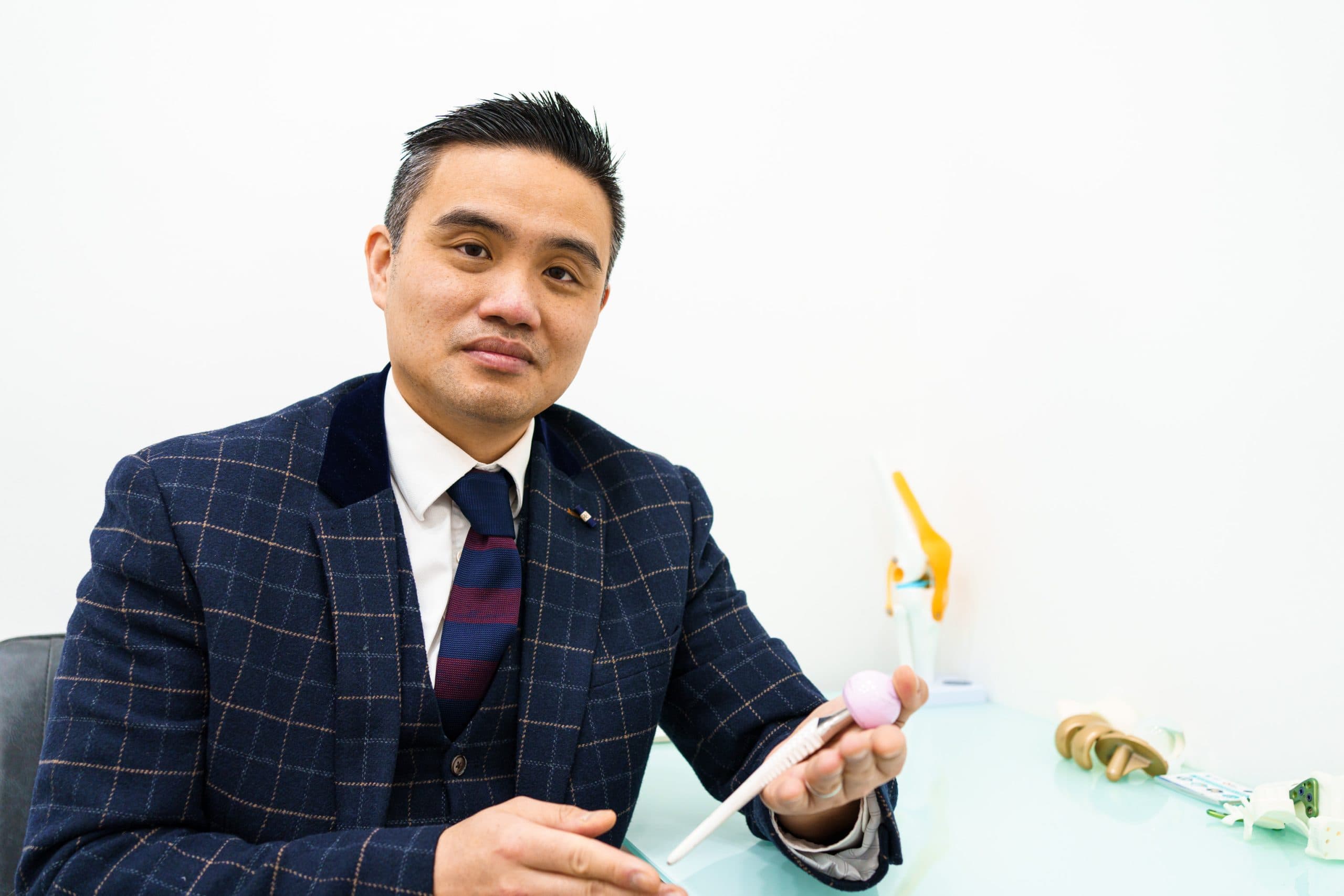 Doctor demonstrating implant beside patient